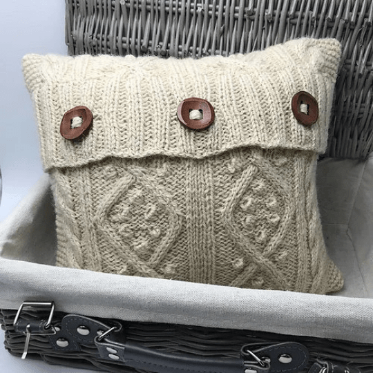 Aran Cushion Knitting Kit with cables and buttons on the closing flap