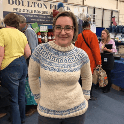 Woman wearing Aran yoked woolen Sweater knitting kit made from Border Leicester Yarn