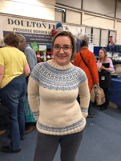 Woman wearing Aran yoked woolen Sweater knitting kit made from Border Leicester Yarn