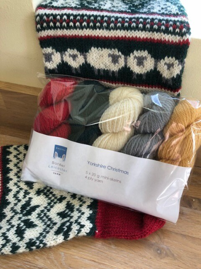 Yorkshire Christmas pack of 4ply mini skeins contains 5 20g/60m skeins of yarn in deep green, rich red, golden yellow, silver grey and ivory