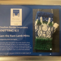 Sam the Ram Lamb Mitts Knitting Kit in a rectangular hinged-lid tin. Perfect gift for knitters.
