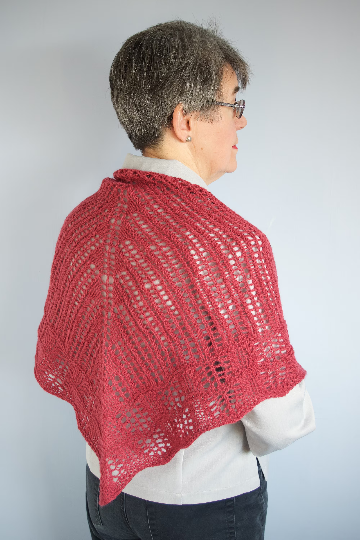 Woman wearing single skein, knitting kit shawlette made from border leicester yarn