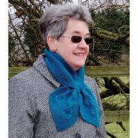 woman wearing a knitted scarf falling leaves pattern