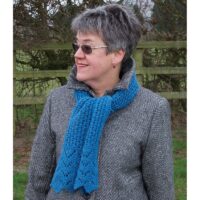 woman wearing a horse shoe lace knitted scarf