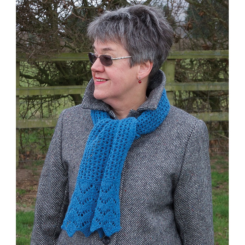 woman wearing a horse shoe lace knitted scarf