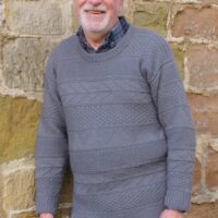 Man wearing woolen sweater knitting kit made from border leicester yarn