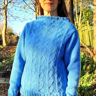 Woman wearing Loschy Hill knitted sweater knitting kit made from border leicester aran yarn