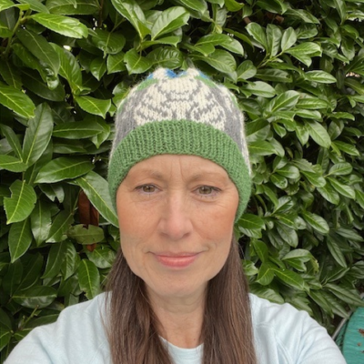 Woman wearing woolen hat knitting kit made from border leicester yarn