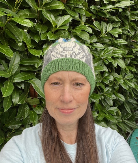 Woman wearing woolen hat knitting kit made from border leicester yarn